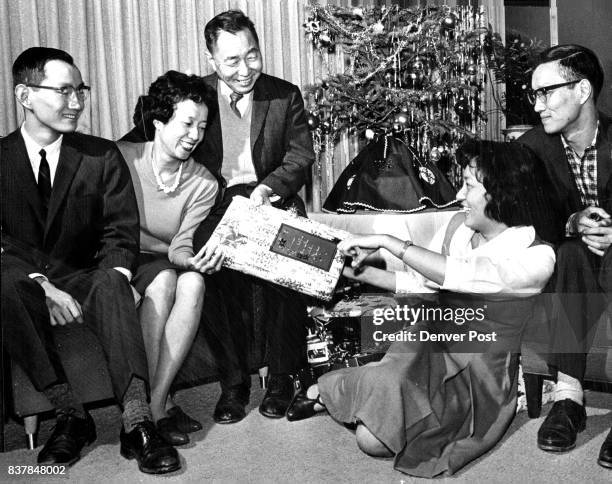 The Chien Wen L. Wang Family is Finally Reunited After 19 Years Mr. And Mrs. Wang, at left of Christmas tree, and son, Richard welcome daughter,...
