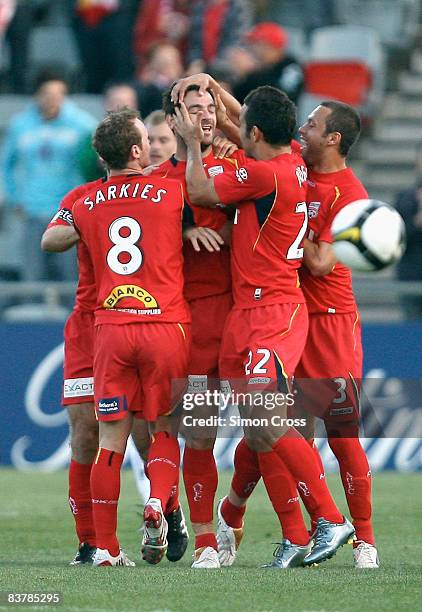 United players congratulate team mate Sasa Ognenovski after he scored the opening goal during the round 12 A-League match between Adelaide United and...