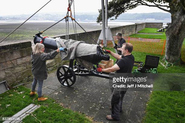 Tim Martin, Mathew Packer and Leesa Vere Stevens place a restored canon captured at Sebastapol in 1856 onto the town walls on August 23, 2017 in...