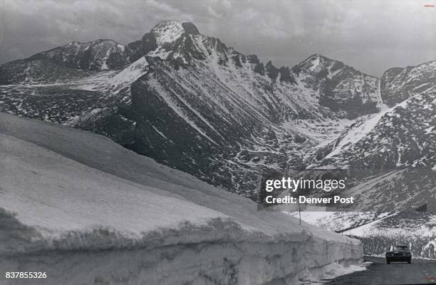 Magnificent scenery awaits the motorist who travels trail ridge road in Rocky Mountain National Park in June. The majestic peak at left center is...