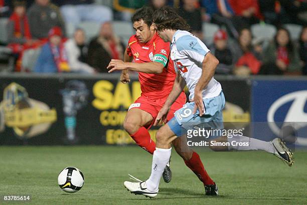 Travis Dodd of United runs past Beau Busch of Sydney during the round 12 A-League match between Adelaide United and Sydney FC at Hindmarsh Stadium on...