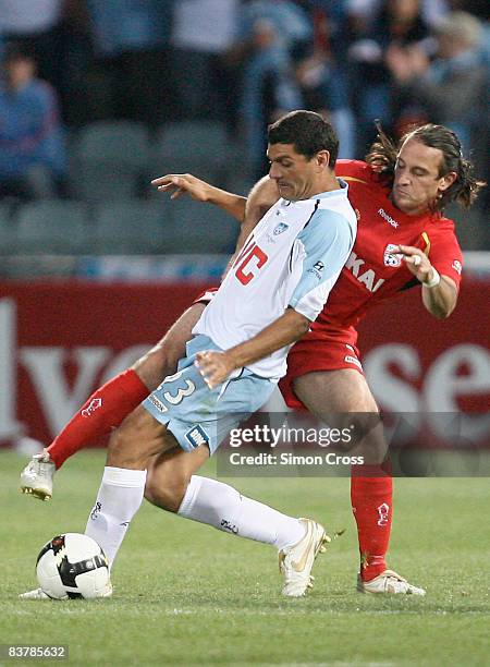 John Aloisi of Sydney is tackled by Angelo Costanzo of United during the round 12 A-League match between Adelaide United and Sydney FC at Hindmarsh...