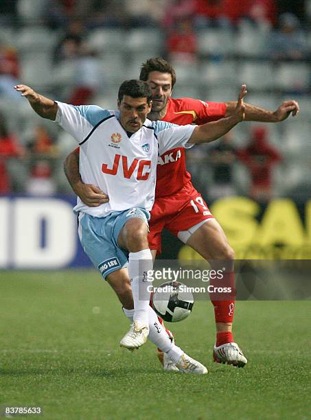 John Aloisi of Sydney is tackled by Sasa Ognenovski of United during the round 12 A-League match between Adelaide United and Sydney FC at Hindmarsh...