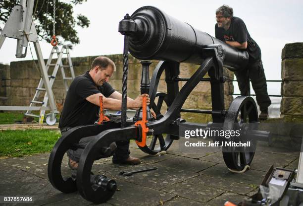 Tim Martin and Mathew Packer place a restored canon captured at Sebastapol in 1856 onto the town walls on August 23, 2017 in Berwick-upon-Tweed,...