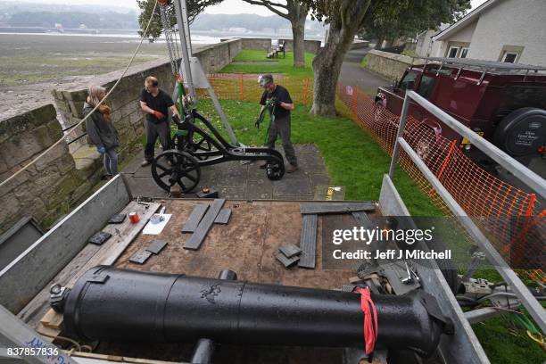 Tim Martin, Mathew Packer and Leesa Vere Stevens place a restored canon captured at Sebastapol in 1856 onto the town walls on August 23, 2017 in...