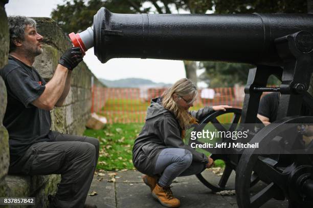 Tim Martin and Leesa Vere Stevens place a restored canon captured at Sebastapol in 1856 onto the town walls on August 23, 2017 in Berwick-upon-Tweed,...