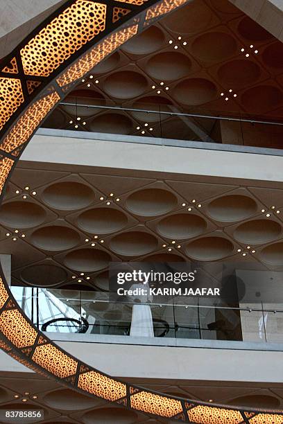 Qatari visitor stands by a railing at the new Museum of Islamic Art in Doha on November 22, 2008. Around 1000 guest celebrities including politicians...