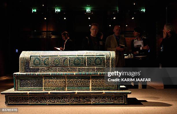 Foreign media look at an engraved sarcophagus at the new Museum of Islamic Art in Doha on November 22, 2008. Around 1000 guest celebrities including...