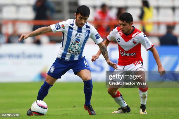 Edson Puch of Pachuca struggles for the ball with Jesus Paganoni of Veracruz during the sixth round match between Pachuca and Veracruz as part of the...