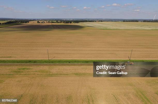 In this aerial view a worker drives a specialzed vehicle that is laying tubing used for running fiber optic cable underground during the installation...