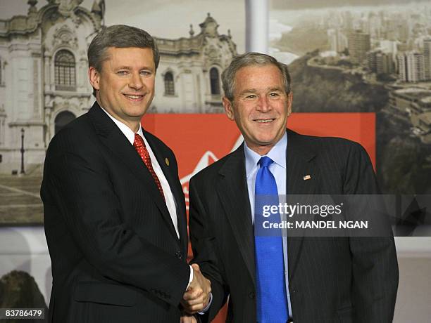 President George W. Bush shakes hands with Canadian Prime Minister Stephen Harper chat on November 22, 2008 during a bilateral meeting on the...