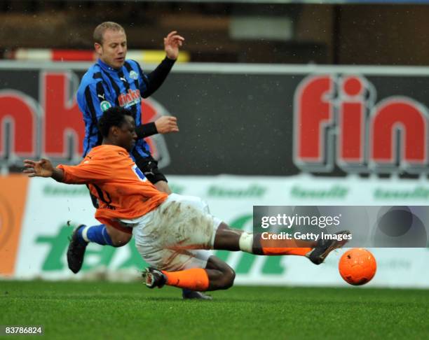 Moses Sichone of Aalen tackles Frank Loening of Paderborn during the 3. Bundesliga match between SC Paderborn and VFR Aalen at the Paragon Arena on...
