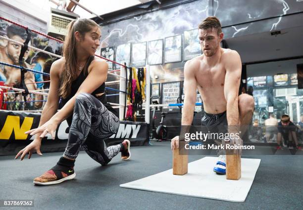 Callum Smith stretches off after a training session with his yoga teacher Raquelle Gracie at Gallaghers Gym on August 23, 2017 in Bolton, England.