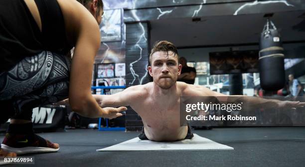 Callum Smith stretches off after a training session with his yoga teacher Raquelle Gracie at Gallaghers Gym on August 23, 2017 in Bolton, England.