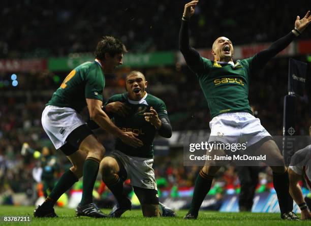 Bryan Habana of South Africa celebrates his try with team mate Conrad Jantjes and Jaque Fourie during the Investec Challenge match between England...