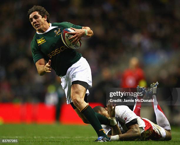 Jaque Fourie of South Africa evades a tackle by Delon Armitage of England to score a try during the Investec Challenge match between England and...