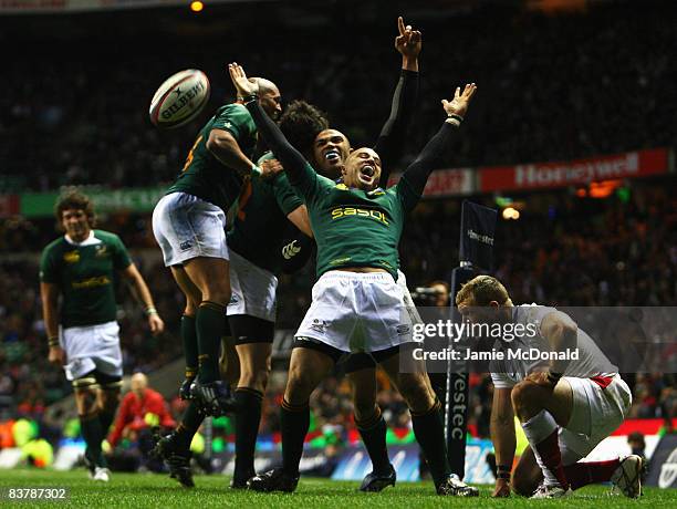 Bryan Habana of South Africa celebrates his try with team mate Conrad Jantjes during the Investec Challenge match between England and South Africa at...