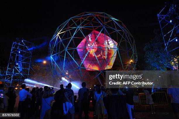 An artist from Close-Act Theatre of Netherlands performs in a large sphere titled "Globe" during a media preview of the Night Festival in Singapore...