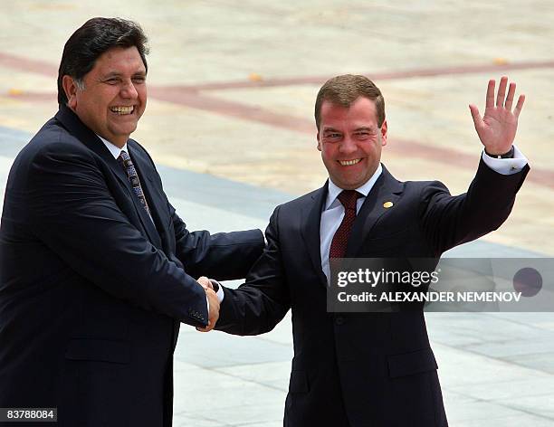 Russia's President Dmitry Medvedev is welcomed by Peru's President Alan Garcia upon arriving to attend the Asia-Pacific region retreat 1 meeting on...