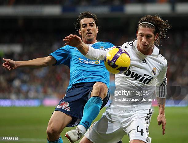 Sergio Ramos of Real Madrid duels for the ball with Francisco Javier Garcia of Recreativo Huelva during the La Liga match between Real Madrid and...