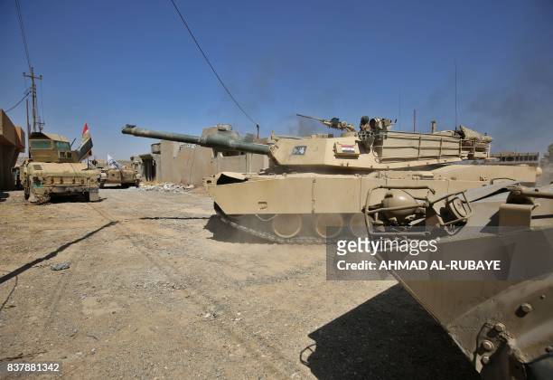 Tank belonging to the Iraqi forces, backed by Shiite fighters from the Popular Mobilization Forces, advances inside al-Nour neighbourhood, in eastern...