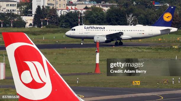 An Air Berlin airplane is seen on the tarmac at Tegel Airport as a Lufthansa plane taxis on August 23, 2017 in Berlin, Germany. Air Berlin's...