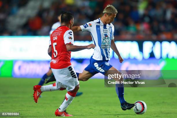 Keisuke Honda of Pachuca struggles for the ball with Guido Milan of Veracruz during the sixth round match between Pachuca and Veracruz as part of the...