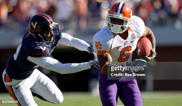Jacoby Ford of the Clemson Tigers picks up a first down as he is tackled by Ras-I Dowling of the Virginia Cavaliers at Scott Stadium on November 22,...