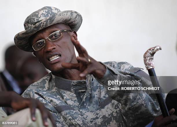 Rebel leader Laurent Nkunda gestures as he speaks with one of his officers at the stadium in the North Kivu town of Rutshuru on November 22, 2008....