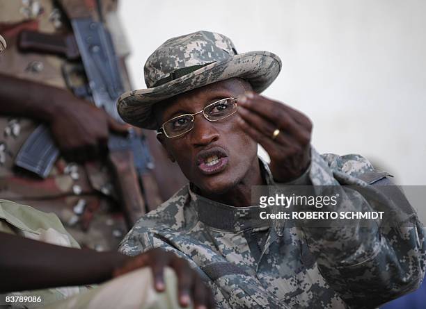 Rebel leader Laurent Nkunda gestures as he speaks with one of his officers at the stadium in the North Kivu town of Rutshuru on November 22, 2008....