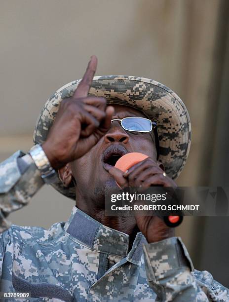 Rebel leader Laurent Nkunda gestures as he speaks with one of his officers at the stadium in the North Kivu town of Rutshuru on November 22, 2008....