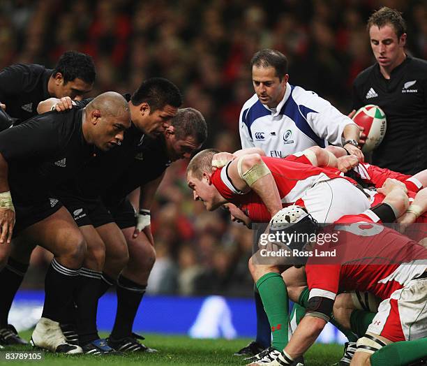 Refewree Jonathan Kaplan looks on as Neemia Tialat Keven Mealamu and John Afoa of the All Blacks pack down in the scrum against Gethin Jenkins during...