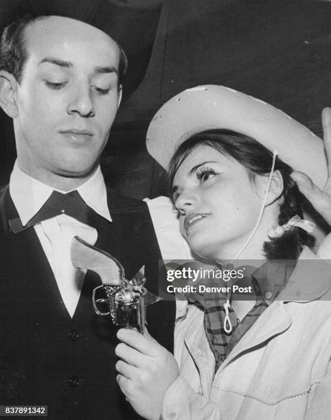 Sean Hennessey, as Wild Bill Hickok, accepts a revolver in surrender from Calamity Jane, played by Darlene Garlutzo, in this scene from "The...