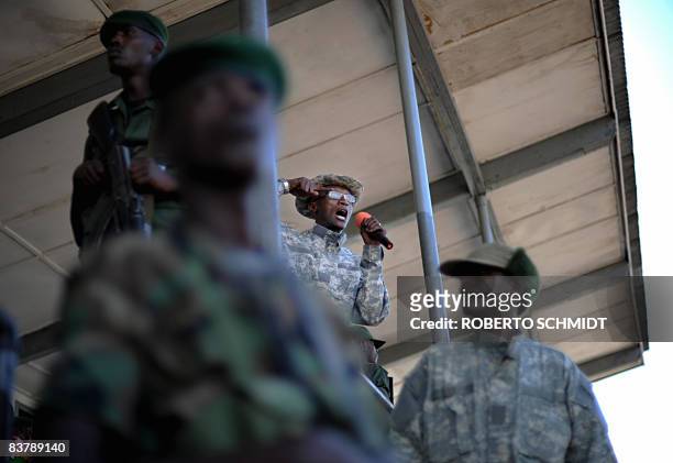 Rebel leader Laurent Nkunda speaks to a crowd at the stadium in the North Kivu town of Rutshuru on November 22, 2008. About 1,500 people packed the...