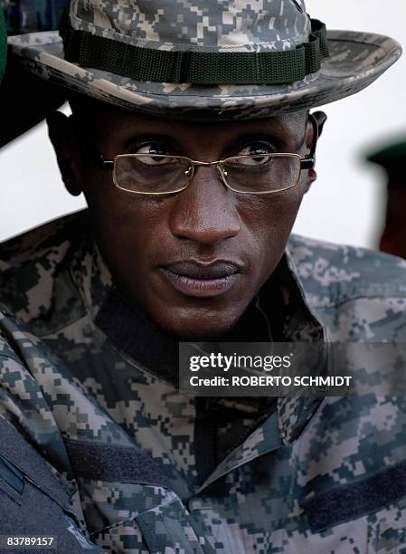 Rebel leader Laurent Nkunda looks from behind his gold-rimmed glasses before addressing a crowd at the local stadium in the North Kivu town of...