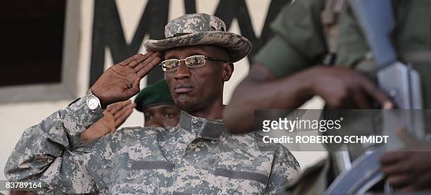 Rebel leader Laurent Nkunda stands at attention as he listens to the anthem of the National Congress for the Defense of the People at the stadium in...