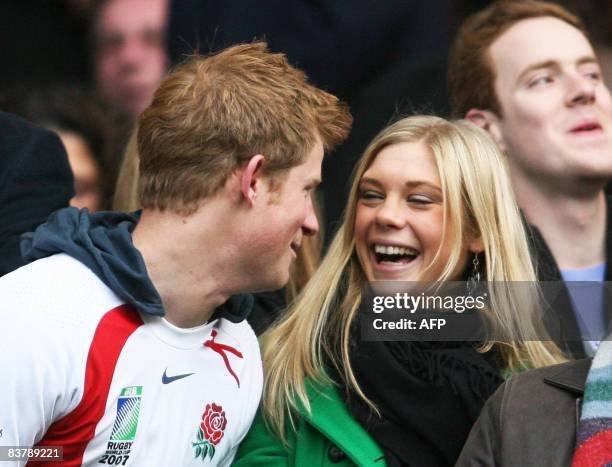 Britain's Prince Harry and Chelsy Davy laugh before the game between South Africa and England at the Investec Challenge international rugby match at...