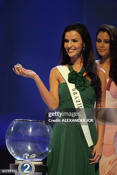 Miss Brazil Tamara Almeida Silva picks a ball with the name of a team during the Final Confederations Cup draw at Sandton Covention Centre in...