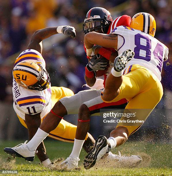 Mike Wallace of the Ole Miss Rebels is tackled by Rahim Alem of the Louisiana State University Tigers on November 22, 2008 at Tiger Stadium in Baton...