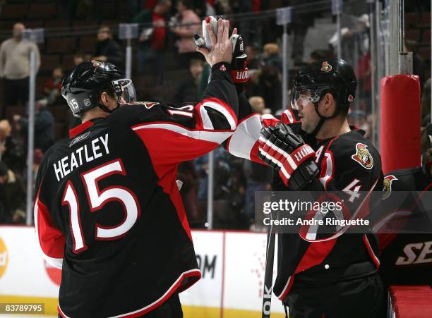 Dany Heatley and Chris Phillips of the Ottawa Senators high-five each other after their win against the New York Rangers at Scotiabank Place on...