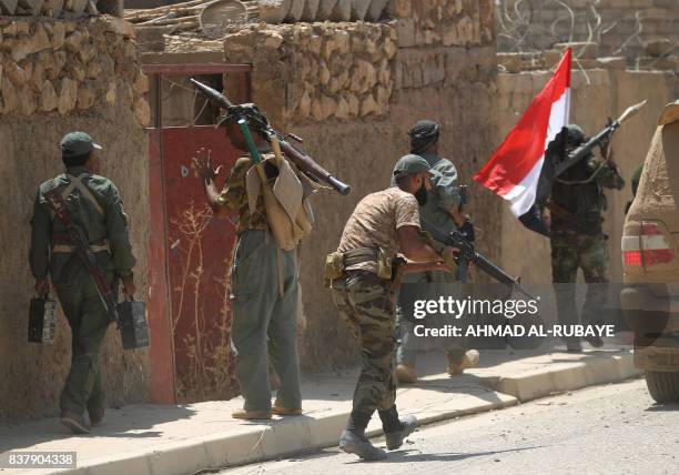 Fighters from the Hashed Al-Shaabi advance inside al-Nour neighbourhood, in eastern Tal Afar, the main remaining stronghold of the Islamic State...