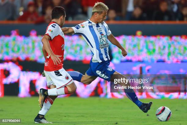 Keisuke Honda of Pachuca kicks the ball to score the fourth goal of his team against Jesus Paganoni of Veracruz during the sixth round match between...