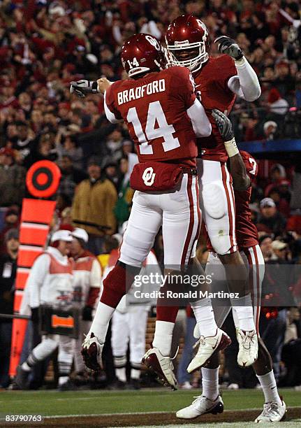 Quarterback Sam Bradford of the Oklahoma Sooners celebrates a touchdown with Jermaine Gresham during play against the Texas Tech Red Raiders in the...