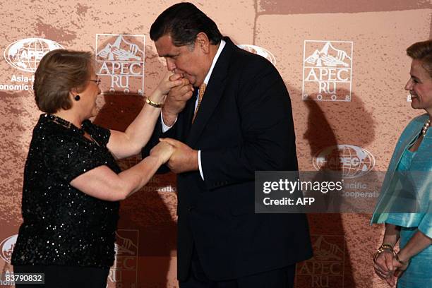 Chile's President Michelle Bachelet is welcomed by Peru's President Alan Garcia and First Lady Pilar Nores upon arriving for the official dinner of...