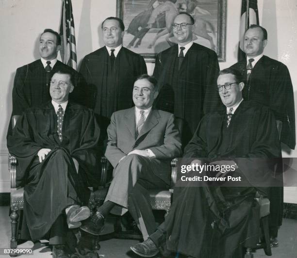 Mayor Newton poses with municipal court judges who have joined judges of other courts located in Denver in wearing black robes in court. Seated and...