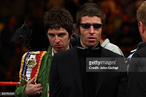 Noel and Liam Gallagher of Oasis bring out boxer Ricky Hatton of England's belts before taking on Paulie Malignaggi during their light-welterweight...