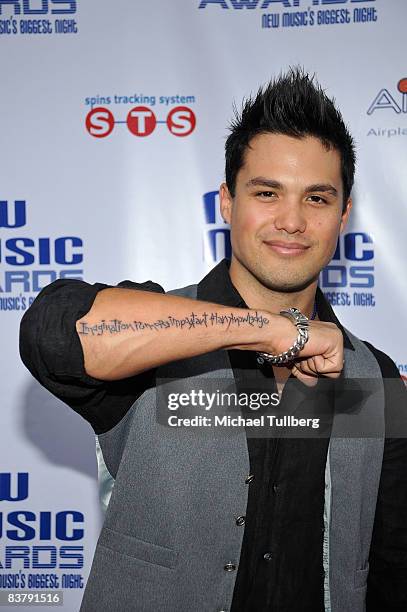 Actor Michael Copon shows off a tattoo on his arm of Albert Einstein's quote: "Imagination is more important than knowledge" at the New Music Weekly...