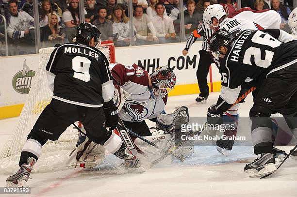 Peter Budaj of the Colorado Avalanche defends in the net against Drew Doughty and Michal Handzus of the Los Angeles Kings during the game on November...