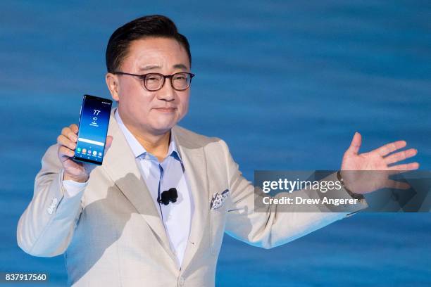 Koh, president of mobile communications business at Samsung, holds up the new Samsung Galaxy Note8 smartphone during a launch event for the new...