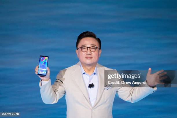Koh, president of mobile communications business at Samsung, holds up the new Samsung Galaxy Note8 smartphone during a launch event for the new...